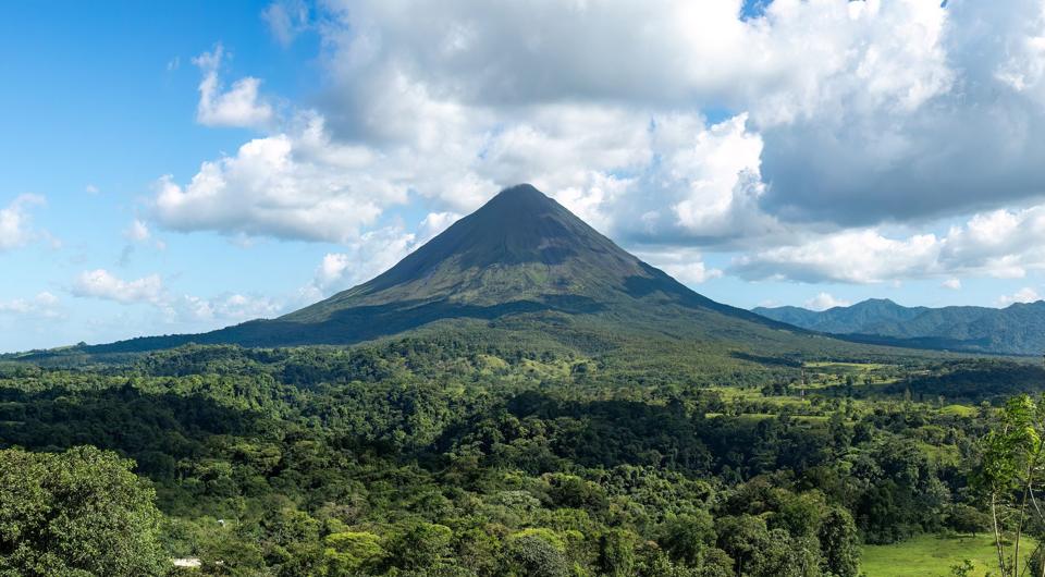 Arenal volcano rising over rainforest