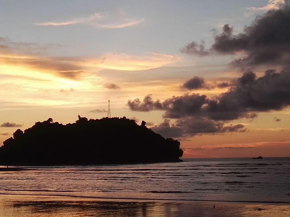 Sunset over rocky islets at Nuquí