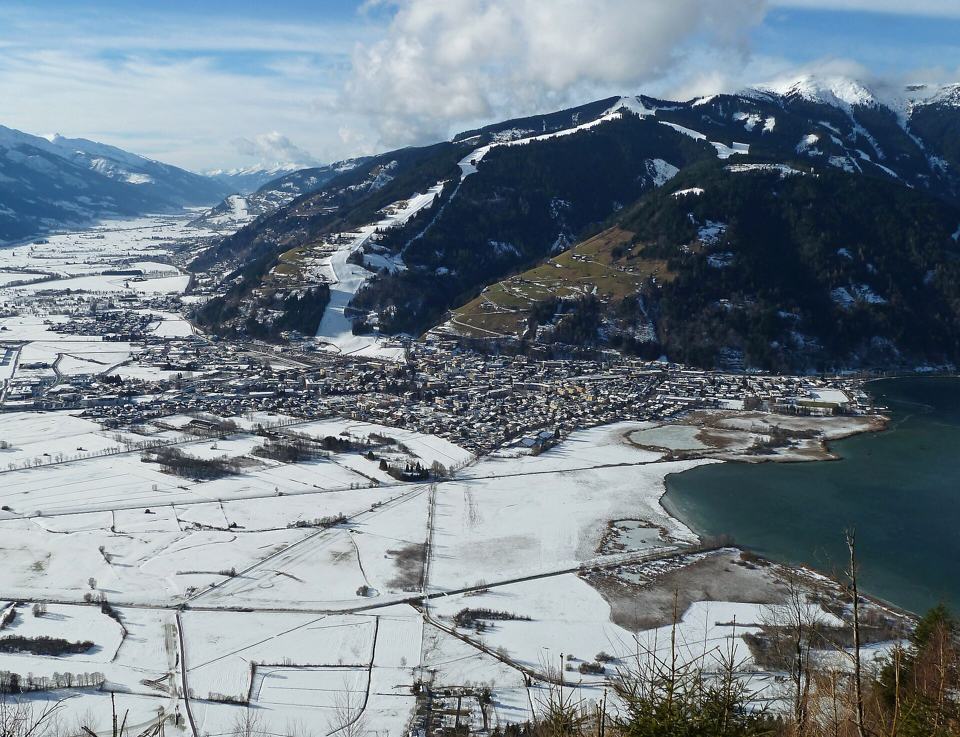 Snowy Zell am See town and lake below ski runs on the mountain