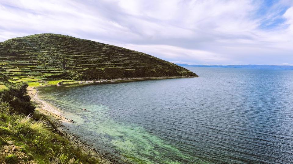 Terraced hillside and turquoise bay on Isla del Sol, Lake Titicaca