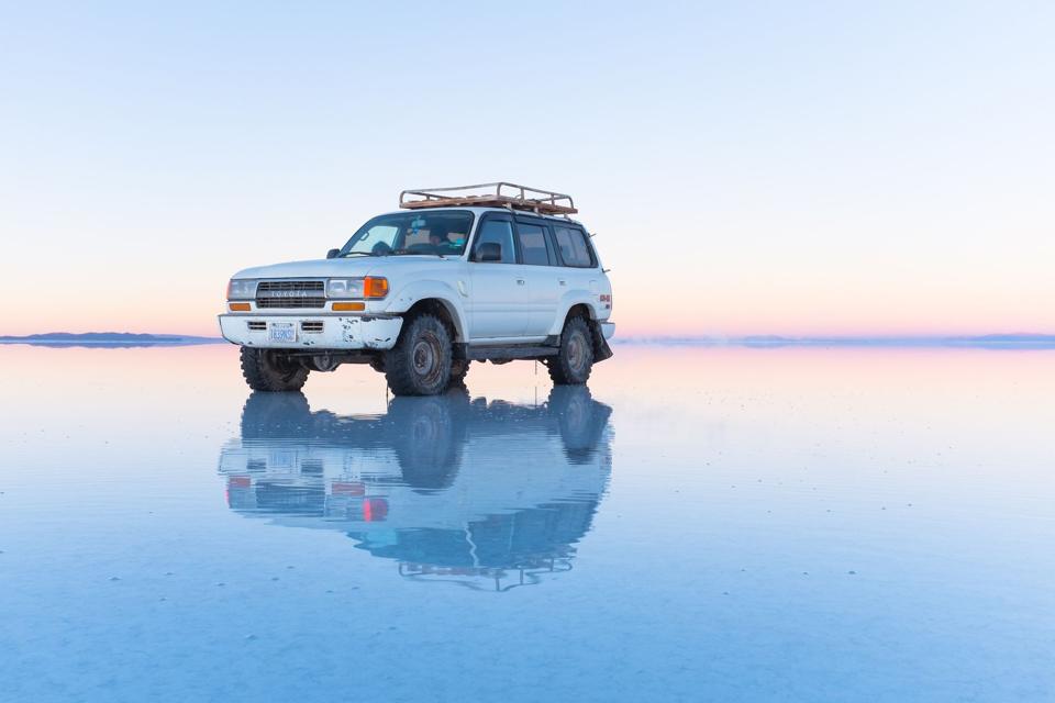 A 4x4 reflected perfectly on the flooded Salar de Uyuni