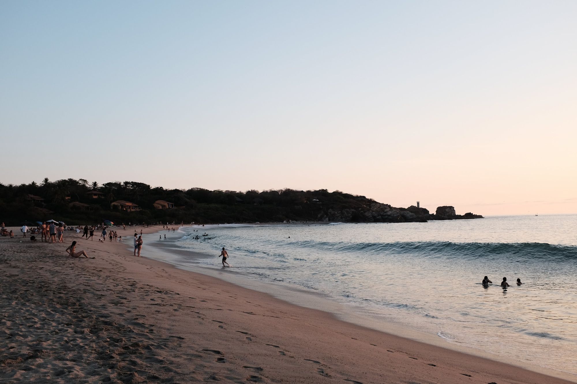 Swimmers at dusk on La Punta, Zicatela, Puerto Escondido